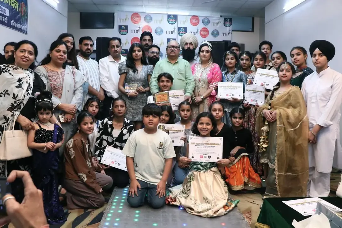 Participants and their families holding certificates after a prize ceremony